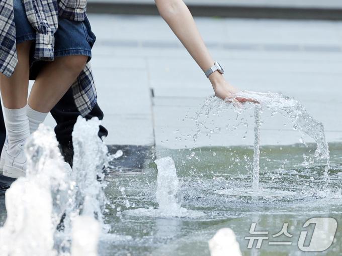 대체로 맑고 포근한 '초여름 날씨'를 보인 12일 오후 서울 광화문광장 분수터널에서 시민들이 더위를 식히고 있다. 2025.5.12/뉴스1 ⓒ News1 황기선 기자