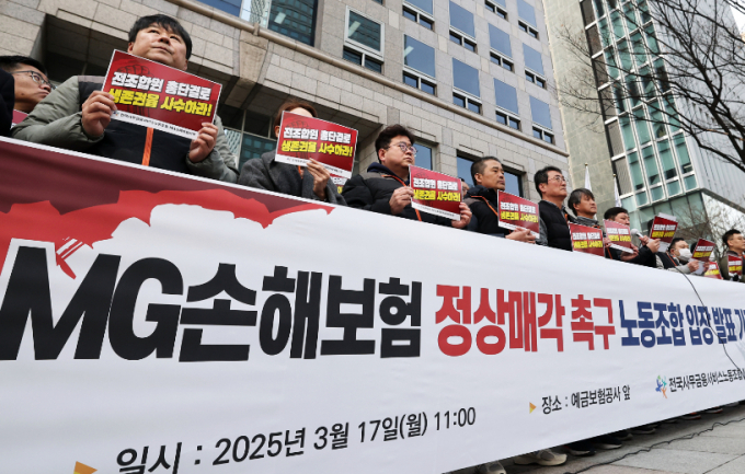 MG손해보험노조 소속 조합원들이 지난달 17일 서울 중구 예금보험공사 앞에서 열린 MG손해보험 정상매각 촉구 입장 발표 기자회견에서 생존권 사수 문구가 적힌 피켓을 들고 있다. /사진=뉴스1 오대일 기자