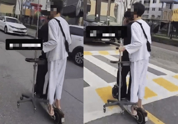 학생으로 추정되는 남성 두 명이 전동 킥보드 한 대를 함께 타고 주행하는 영상이 확산했다.  사진은 헬멧을 착용하지 않은 두 명이 전동 킥보드에 탑승한 모습. /사진=온라인커뮤니티 '보배드림' 캡처