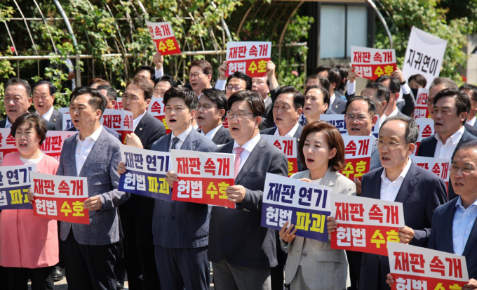 김용태 국민의힘 비상대책위원장과 권성동 원내대표 등 참석 의원들이 11일 오전 서울 서초구 서울고등법원에서 법원의 이재명 대통령 공직선거법 위반 파기환송심 기일 추후 지정 결정을 비판하는 현장의원총회를 열고 구호를 외치고 있다./사진제공=뉴시스