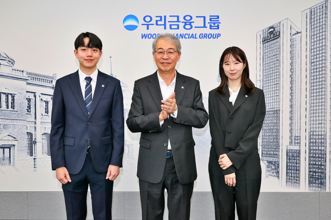 우리금융그룹 임종룡 회장(왼쪽)이 1일 서울 중구 우리금융지주 본사에서 그룹의 새 가족이 된 동양생명·ABL생명 직원에게 디지털 선도의 의미가 담긴 그룹 보조휘장을 달아주고 있다./사진=우리금융그룹