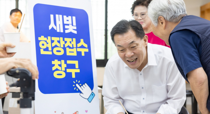 이재준 수원시장이 31일 우만종합사회복지관에 설치한 찾아가는 새빛현장접수청구를 방문해 한 노인과 이야기를 나누고 있다. /사진제공=수원시 