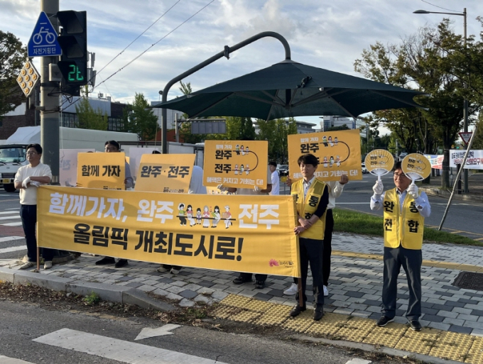 전주시·완주전주통합추진위원회 관계자 등 100여 명이 통합 주민투표를 앞두고 15일 전주와 완주 접경지역 주요 교차로에서 '완주·전주 통합 출근길 캠페인'을 하고 있다./사진=전주시