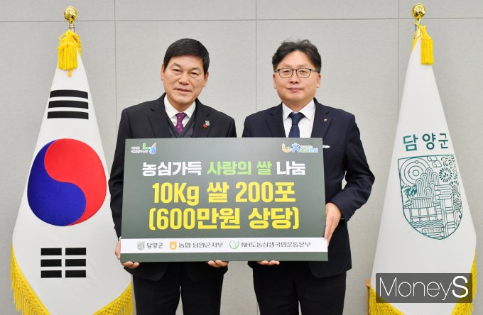 이광재 농협담양군지부장이 연말을 맞아 정철원 담양군수(왼쪽)에게 관내 소외계층을 위한 사랑의 쌀을 전달하고 있다/사진=농협전남본부 제공.