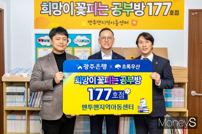 임양진 광주은행 부행장(가운데)은 최근 '희망이 꽃피는 공부방' 177호점으로 선정된 광주 서구 맨투맨지역아동센터에 학습환경 개보수 비용을 전달하고 있다/사진=광주은행 제공.