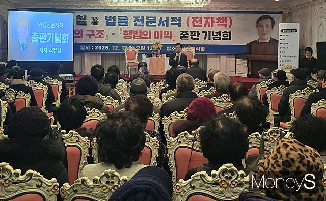  최유철 법무사가 17일 경북 의성군 의성읍 소재 의성읍 궁전예식장에서 저서 '민법의 구조'와 '형법의 이익' 출판기념회에서 자신의 저서를 소개하고 있다./사진=황재윤 기자