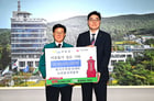 정종복 기장군수(왼쪽)가 이상욱 고리본부장으로부터 성금을 전달받고 기념촬영을 하고 있다./사진=기장군